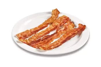 Denny’s crispy strips of bacon served on a white plate.
