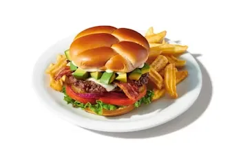 Denny’s Bacon Avocado Cheeseburger stacked with beef patty, cheese, bacon, and avocado.