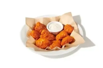 Denny’s Boneless Chicken Wings tossed in sauce and served with dipping ranch.