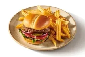 Denny’s Classic Burger with beef patty, lettuce, tomato, cheese, and fries.