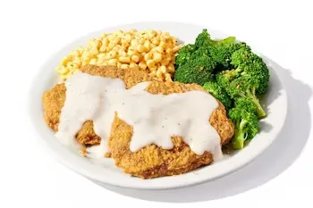 Denny’s Country-Fried Steak Dinner with creamy gravy, mashed potatoes, and broccoli.