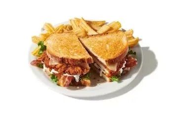 Denny’s Crispy Bacon Ranch Sandwich with fried chicken, ranch dressing, lettuce, and crispy bacon.