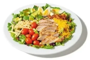 Denny’s Egg-Cellent Grilled Chicken and Bacon Cobb Salad with lettuce, tomatoes, and cheese.