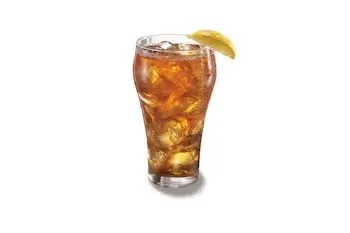 Denny’s Fresh Brewed Iced Tea served over ice in a tall glass.