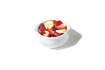Denny’s fresh seasonal fruit bowl with strawberries and melon pieces.