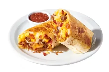 Denny’s Grand Slam Burrito stuffed with scrambled eggs, cheese, bacon, sausage, and served with a side of salsa.
