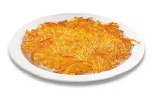 Denny’s crispy golden hash browns served on a plate.