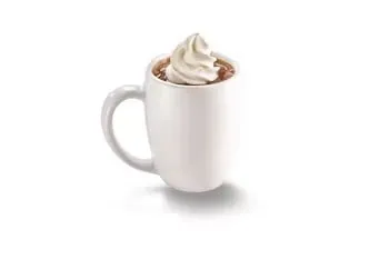 Denny’s Hot Chocolate topped with whipped cream served in a mug.