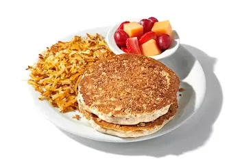 Denny’s Plant-Based Slam with plant-based sausage, hash browns, eggs, and seasonal fruit.