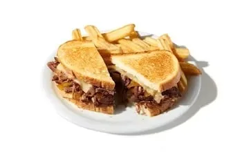 Denny’s Pot Roast Melt sandwich with slow-cooked roast beef, melted cheese, and toasted bread.