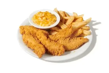 Denny’s Premium Chicken Tenders Dinner with crispy fried tenders, fries, and dipping sauce.