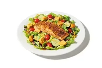 Denny’s Salmon Way Grilled Salmon Salad with fresh greens, grilled salmon fillet, tomatoes, and dressing.