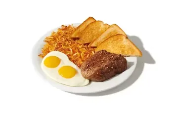 Denny’s Sirloin Steak and Eggs with juicy grilled steak, sunny-side eggs, hash browns, and toast.