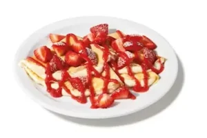 Denny’s Strawberry Vanilla Crepes topped with fresh strawberries and cream.