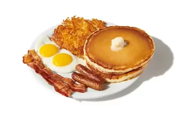 Denny’s Super Slam with pancakes, eggs, bacon, sausage, and golden hash browns.