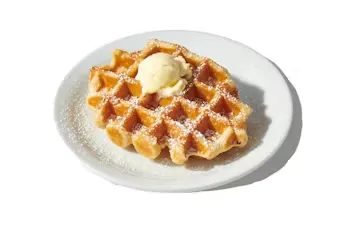 Denny’s classic golden waffle served plain on a white plate.